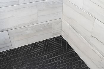 A close up of the black and white subway tile in the shower
